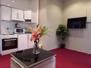 a kitchen with a vase of flowers on a table at Bue waves in Kuwait