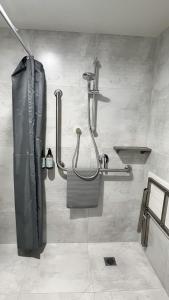 a bathroom with a shower and a sink at Archway Motels & Chalets in Wanaka +62 photos