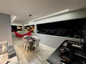 a dining room with a table and a view of a city at Arcoverde - Varanda com Vista Panorâmica - excelente localização - até 6 pessoas in Arcoverde