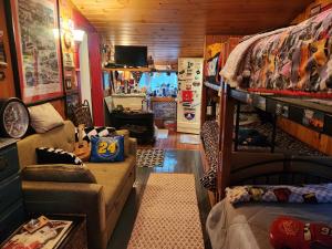 a living room with a couch and a bunk bed at A Meadow House in Lakeville