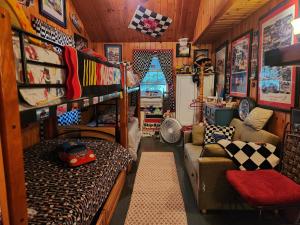 a room with a bunk bed and a couch at A Meadow House in Lakeville