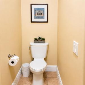 a bathroom with a toilet with a plant on top at Private Master suite with Sauna and Bathtub in Fair Oaks