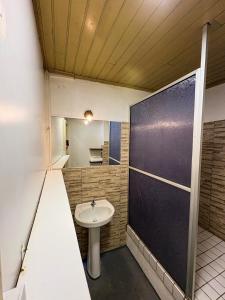 a bathroom with a sink and a black door at Casa Lavinia in São Luís +64 photos