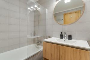 a bathroom with a sink and a mirror and a tub at Atlantic Dutchman Heated Pool & Parking in Caniço +12 photos