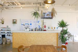 a room with a table and a counter with plants at 535base in Tannowa