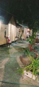 a backyard with chairs and a table and a bench at JUNGLE AERIAL ARTS NAMASTE LA UNION Chi fan kubo 2pax in Rimus