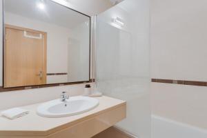 a white bathroom with a sink and a shower at Alta Do Garajau I 5ºw in Caniço +12 photos