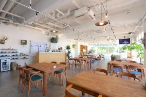 a restaurant with wooden tables and chairs in a room at 535base in Tannowa +55 photos