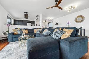 a living room with a blue couch and a table at Casa Afonso Bay Views & Outdoor Living in Funchal