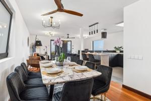a dining room and living room with a table and chairs at Casa Afonso Bay Views & Outdoor Living in Funchal