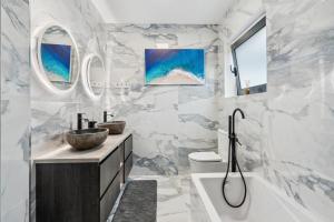 a bathroom with a tub and a sink and a bath tub at Casa Afonso Bay Views & Outdoor Living in Funchal +35 photos