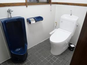 a bathroom with a toilet and a trash can at ASO Uchinomaki Stay in Aso +61 photos