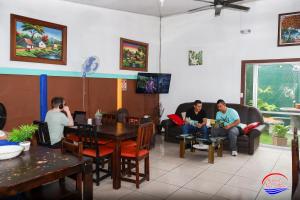 a group of people sitting in a restaurant at Nice Place Hostel in Fortuna