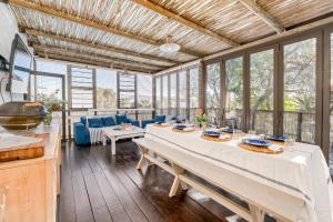 a large dining room with a table and chairs at Coast Unit 5, Bright Escape By Langebaan Lagoon in Langebaan