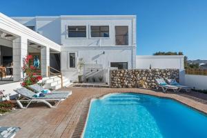 a villa with a swimming pool and a house at Coast Unit 5, Bright Escape By Langebaan Lagoon in Langebaan