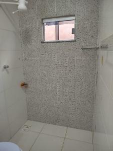a bathroom with a shower with a window at Casa com Ar-Condicionado in Formosa +46 photos