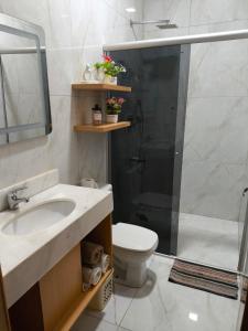 a bathroom with a sink and a toilet and a shower at Casa Quinta MYK in Ciudad del Este +5 photos