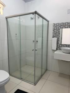 a glass shower in a bathroom with a toilet at San Sebastian Taipu de Fora in Marau +34 photos