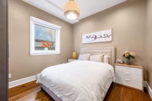 a bedroom with a white bed and a window at Sunnywood Garden in Richmond
