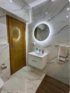 a bathroom with a sink and a mirror at Maison dar allouche in Kelibia
