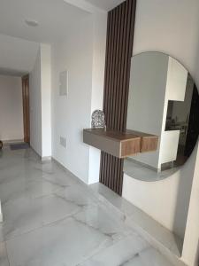 a room with a mirror and a table on a wall at Maison dar allouche in Kelibia