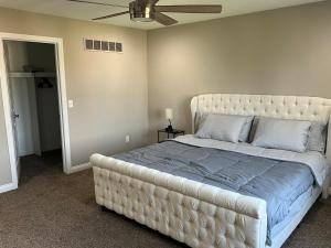 a bedroom with a large bed with a tufted headboard at Sterling Heights Retreat ! in Sterling Heights +26 photos