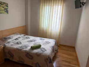 a bedroom with a bed with a green object on it at Hostal Alhambra in Mocejón