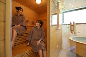 a man and a woman sitting in a sauna at 535base in Tannowa