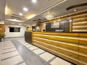 a restaurant lobby with wood paneling and a bar at The Grand Hotel Multan in Multan