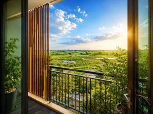 a room with a balcony with a view of the countryside at A30 Hotel & Apartment in Lưu Xá