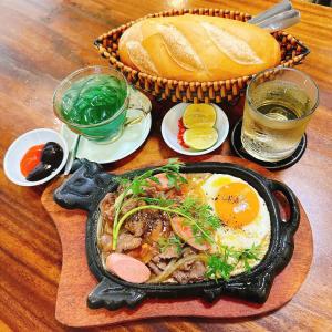 a table with a plate of food with eggs and bread at Apple Phu Quoc Hotel & Restaurant in Phú Quốc +17 photos