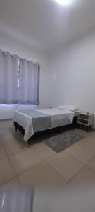 a large bed in a room with at Quarto Privativo ao lado do Aeroporto in Sao Jose do Rio Preto +6 photos