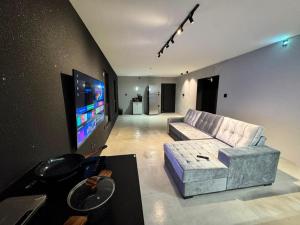 a living room with a couch and a flat screen tv at Arcoverde - Varanda com Vista Panorâmica - excelente localização - até 6 pessoas in Arcoverde +26 photos