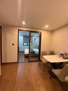 a room with a table and a bedroom with a bed at A30 Hotel & Apartment in Lưu Xá