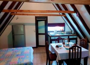 a dining room with a table and a kitchen at private and pleasant in Zapotal