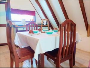 a table with two chairs and a table with bowls on it at private and pleasant in Zapotal +16 photos