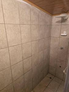a bathroom with a shower with tiled walls at private and pleasant in Zapotal