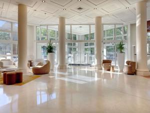a large lobby with chairs and tables and windows at Mercure Montpellier Centre Antigone in Montpellier