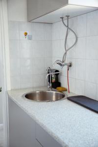 a kitchen counter with a sink and a shower at T&M Apartman in Paraćin +14 photos
