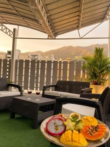 a tray of fruit on a table on a patio at HGO Hotel in Cali