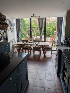 a kitchen and dining room with a table and chairs at Rusthall Prospect House in Speldhurst +16 photos