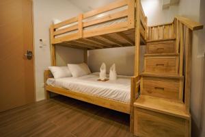 a bunk bed with two rabbits sitting on top of it at Ikigai Narvacan Hometel in Narvacan