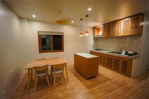 a kitchen with a table and chairs and a counter at Ikigai Narvacan Hometel in Narvacan +40 photos