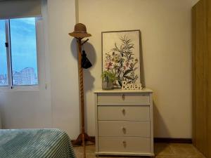 a bedroom with a dresser with a lamp on it at Remodeled Margarita Apt Pool in Porlamar