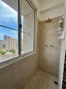 a bathroom with a shower with a large window at Remodeled Margarita Apt Pool in Porlamar