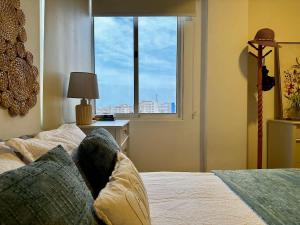 a bedroom with a bed and a window with a view at Remodeled Margarita Apt Pool in Porlamar