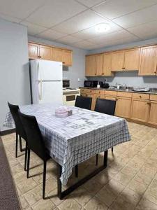 a kitchen with a table with chairs and a refrigerator at 2806 Regina in Regina