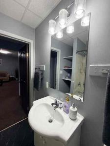 a bathroom with a sink and a mirror at 2806 Regina in Regina +46 photos
