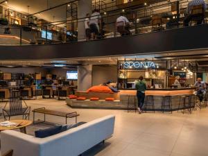 a store with a person sitting at a counter in a building at ibis Sao Paulo Barra Funda in São Paulo