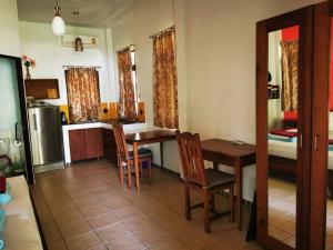 a kitchen and dining room with a table and chairs at Lake View Bungalows in Khao Lak +88 photos